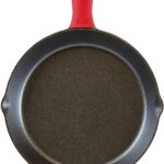 cast iron skillet with red silicone handle.