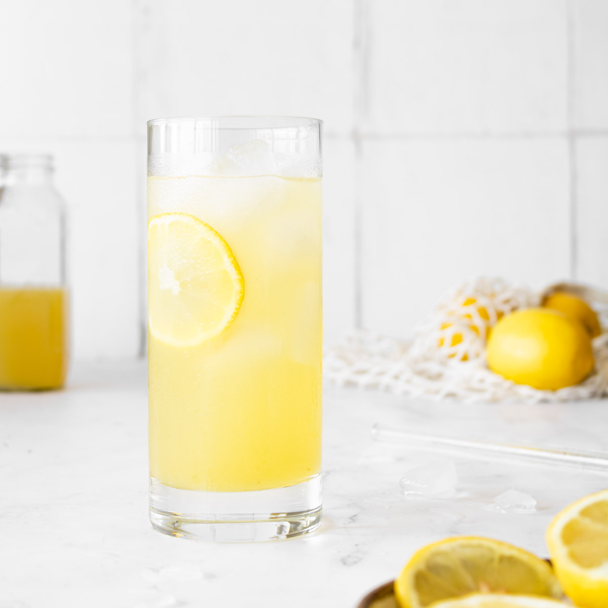 lebanese lemonade in a tall glass with a lemon slice.