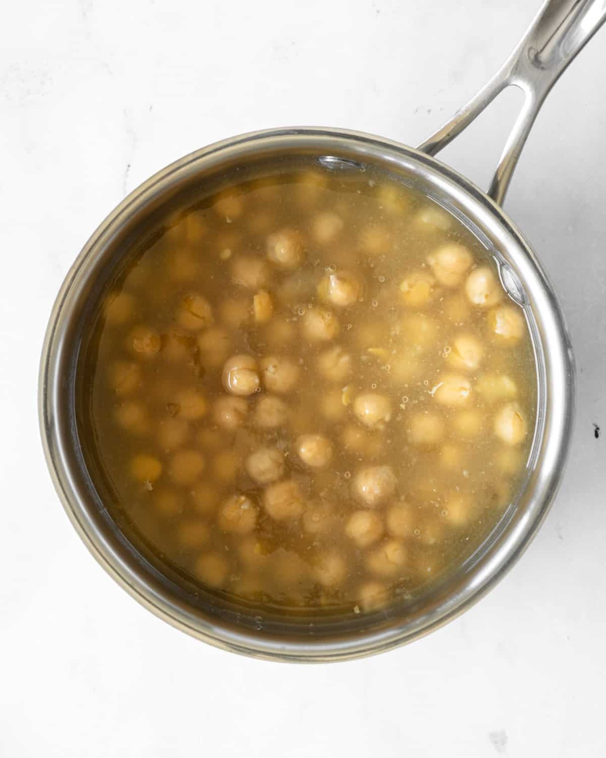 chickpeas and aquafaba in a saucepan.