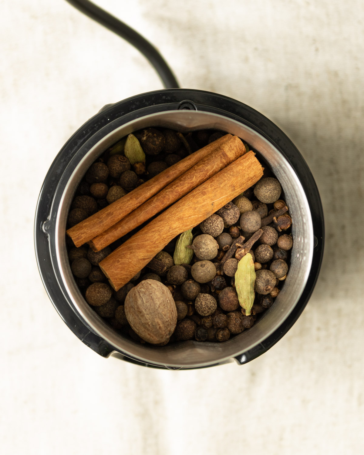 whole spices in an electric spice grinder.